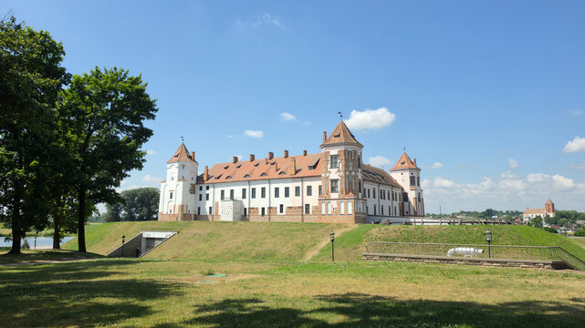 Minsk, Belarus - June 30, 2026: Full view of the historic Mir Castle on green hill