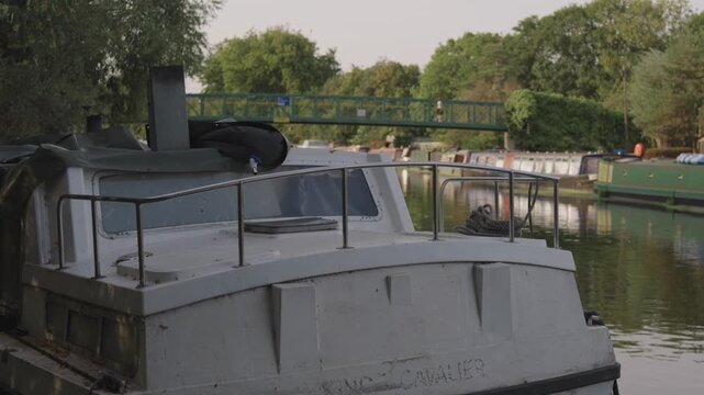 Close-Up of Narrowboat Bow Moored on Canal, Footbridge Behind