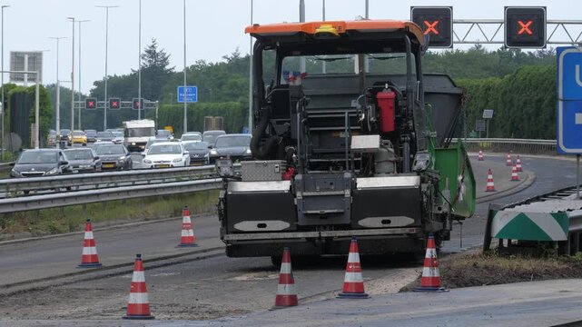 Static Tripod View of Asphalt Paver Machinery on A1