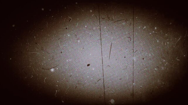 Vintage retro 8mm film grain texture overlay with heavy scratches dust marks and dark vignette flickering effect loop 4k video