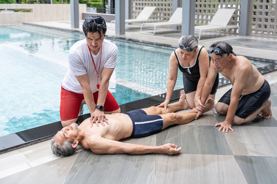 elderly man drowns in a pool,lifeguard rescue first aid help basic life support by the poolside, two senior friends sitting beside look in shock