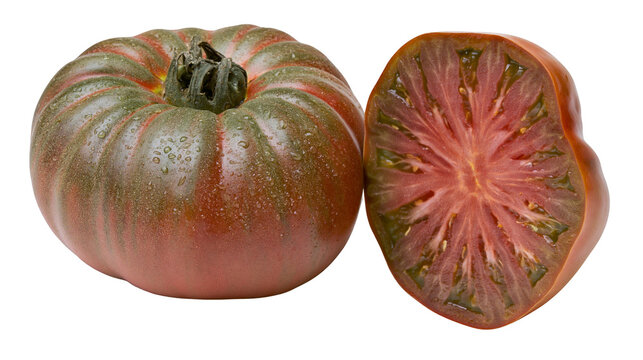 Dark heirloom tomato whole and halved showing juicy red interior, isolated on transparent background