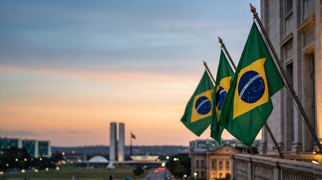 Brazilian flags waving on a building balcony with the National Congress of Brazil in the background at sunset.
