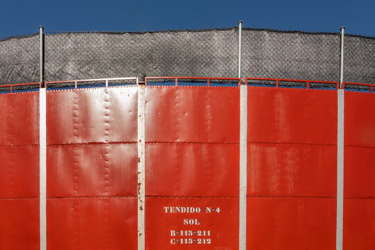 Close-Up of Curved Red Metal Bullring Wall Panels Marked Tendido N-4 Sol Section