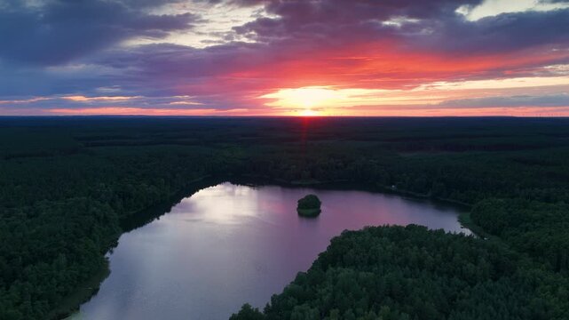 Beautiful sunrise over lake in the forest - aerial high view