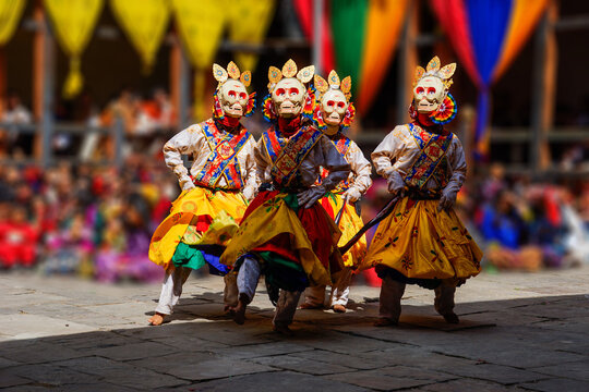 Bhutan, In the village of Bumthang, monks in colorful costumes dance during the annual Jakar festival. blurred background