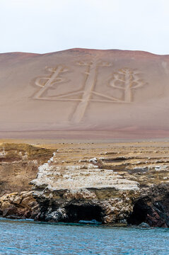 A portrait view from a boat in Paracas Bay towards the Paracas Candelabro geoglyphs, Paracas, Peru in the dry season
