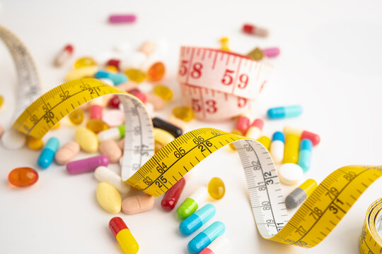 Measuring tape and tablet drug medical for diet.
