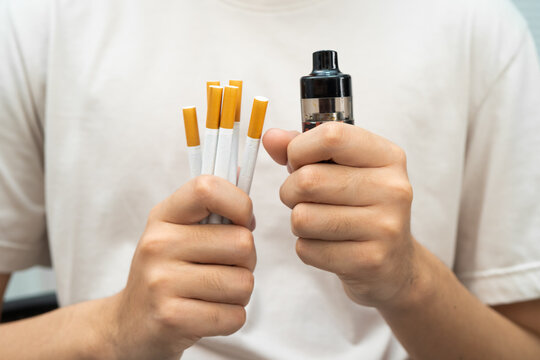 Man holding electronic cigarettes, no smoking.