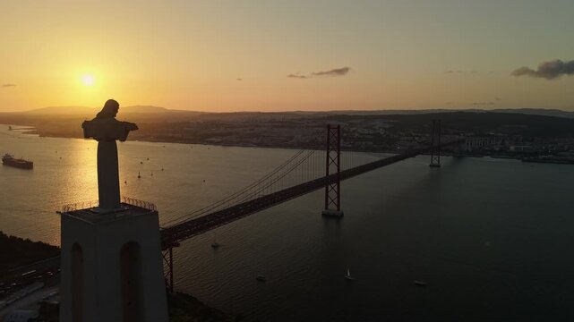 Cristo Rei and 25 April Bridge at Lisbon sunset