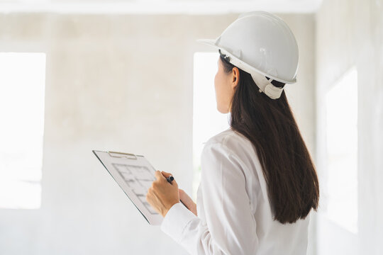 Building inspection asian contractor young woman inspecting home, reconstructed construction, renovation or check defect, before finish handing it over to client, customer. Engineering worker.