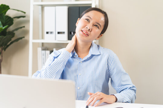 Body muscles stiff problem, ache asian young woman, girl pain neck while sitting work on chair at home, holding massaging rubbing, hurt or sore, Healthcare people, office syndrome.