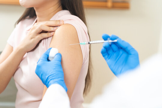 Health care, corona virus, hand of woman nurse, doctor giving syringe vaccine, injection dose on arm sick patient at clinic. Vaccination, immunization disease prevention against flu pandemic influenza