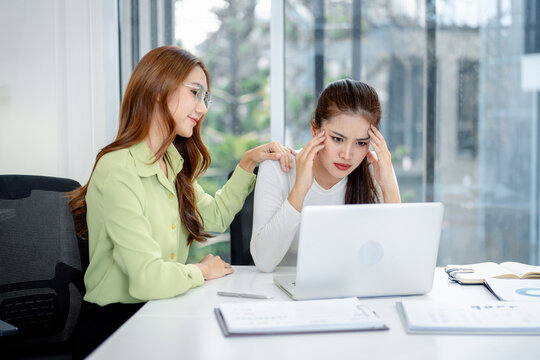 Businesswomen offering support comforting stressed colleague dealing work issue office desk teamwork empathy professional environment