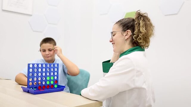 Video of an ENT doctor providing auditory therapy to a child through an educational game. Concept of games for developing auditory skills.