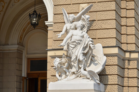 White marble statue of angels and a cherub adorning the facade of the Odessa Opera House. Ancient architecture of Ukraine, opera angel statue 