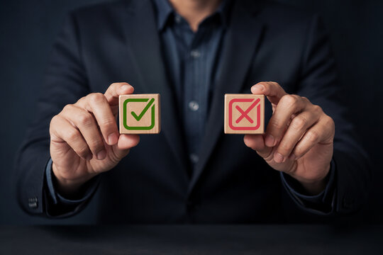 Businessman choosing between right and wrong symbols  representing yes%2Fno decisions  business options  crisis decision-making  and strategic choice concept.
