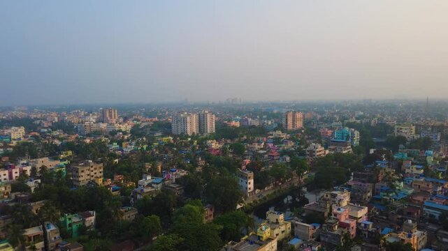 Aerial view of Howrah city skyline with residential buildings and trees, West Bengal, India.