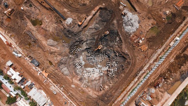 Cleared demolition and construction site with debris and machinery seen from above
