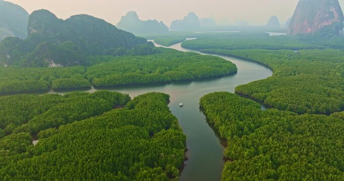 Winding River Around Heart Island. Stunning aerial view of a heart shaped island surrounded by lush mangrove forests and winding rivers in Phang Nga during sunrise.