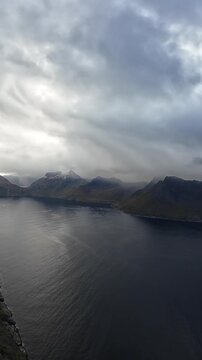Dramatic panoramic view from Segla mountain on Senja island over a fjord and snowy peaks