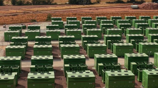 Aerial view of Hams Hall Substation Battery Energy Storage Systems with rows of green energy storage containers at an industrial site in Birmingham, England, United Kingdom.