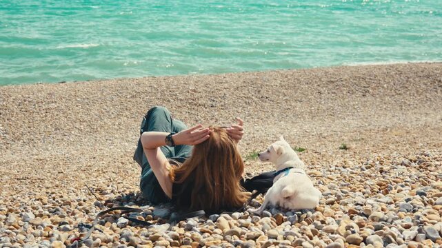 Woman with White Dog Standing on Dover Beach with Sea Background