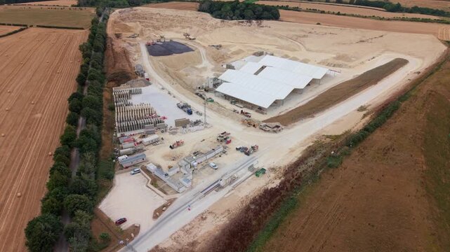 Aerial view of Little Ponton Quarry with heavy plant machinery, industrial buildings, and material stockpiles in Little Ponton, England, United Kingdom.