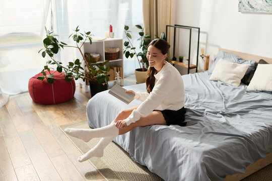 Relaxed young woman enjoys a cozy moment in her modern apartment