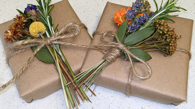 Sustainable gift wrapping with kraft paper and dried flower bouquet, rustic eco packaging on flat lay
