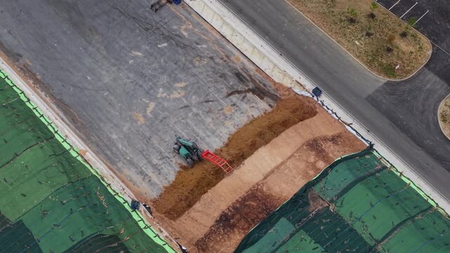 Aerial view of a telehandler moving soil at the Moor Bio Energy construction site in Grantham, England, United Kingdom.