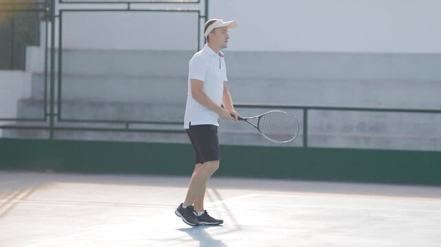 Professional male tennis player hitting forehand stroke