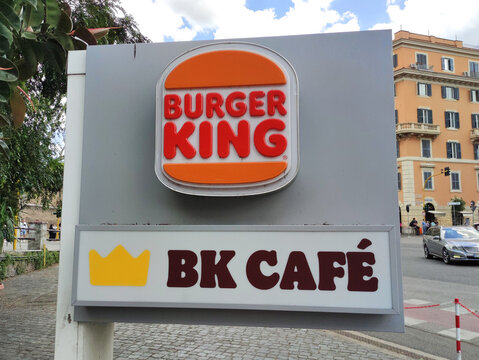 Rome, Italy - May 17, 2026: Burger King restaurant sign featuring logo and BK Cafe branding in urban setting with buildings and street visible in the background