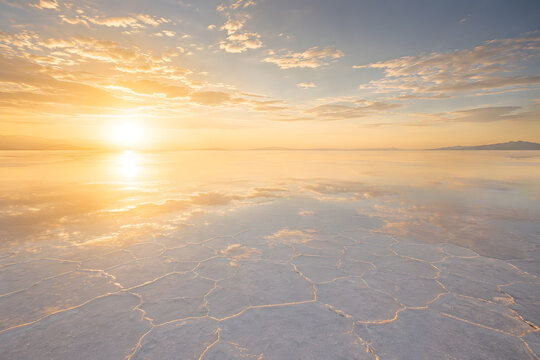 Endless White Salt Desert with Golden Sunrise and Mirror Reflections