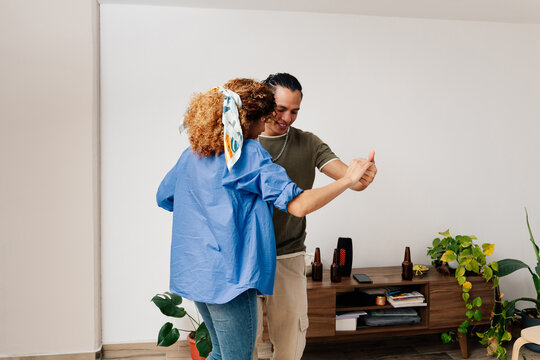 Friends dancing in living room