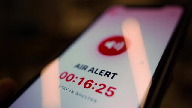 Smartphone screen showing air raid alert with countdown timer close-up 