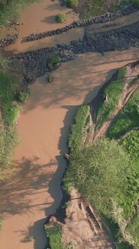 Aerial view of Ewaso Narok River flowing through the lush green landscape of Rumuruti, Laikipia County, Kenya.