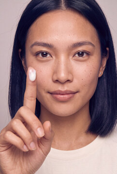 Closeup woman applying cream with fingertip for skincare banner background and beauty routine product advertising
