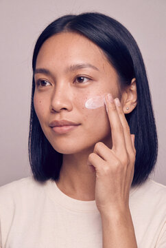 Closeup woman applying facial cream skincare routine for beauty product ad and skin care background