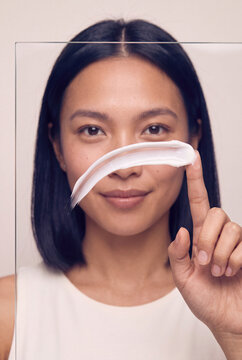 Minimal skincare portrait of a woman applying cream smear on glass for beauty product background and cosmetic banner design