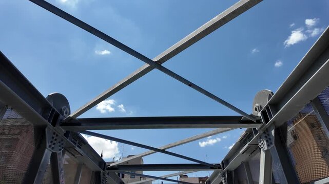 Geometric urban architecture: metal pedestrian bridge from below