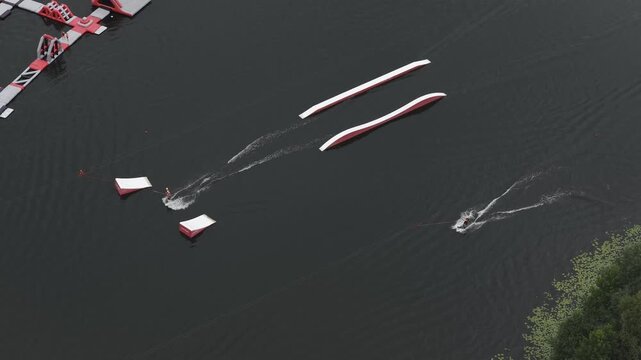 Aerial view of inflatable water park with floating obstacles and ramps on a lake in Vilnius, Vilnius County, Lithuania.