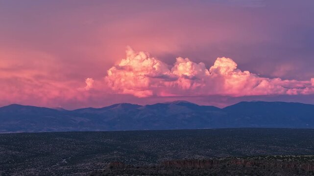 Aerial view of the Sangre de Cristo Range with dramatic sunset clouds over the landscape in Los Alamos, NM, United States.