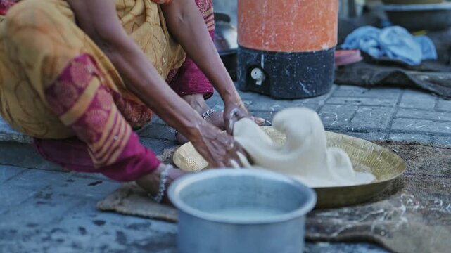 Traditional Indian lambi Roti or Mande Being Cooked in an Earthen Pot in Unhygienic Conditions