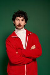 Obraz premium Young man with stylish moustache showcases a striking fashion statement on a vibrant backdrop