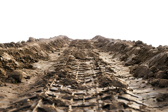 Close up tire tread pressed into wet clay field foreground