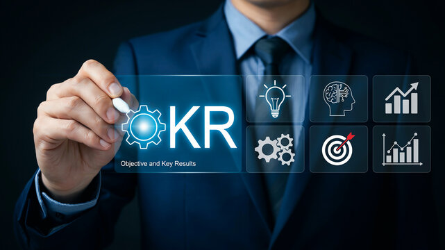 Businessman writing KR Objective and Key Results with digital icons on a screen strategy