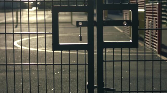 School gates with playground at dusk