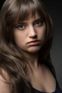 Beautiful teenage girl portrait on dark background for beauty and skincare concept