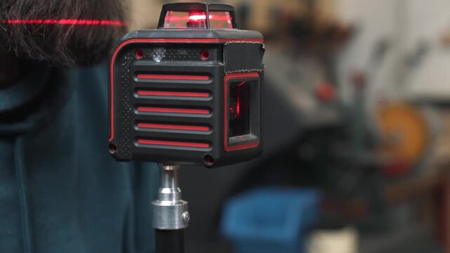 An engineer installs and adjusts a laser level, as precision is important in construction.